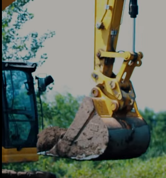 Excavator bucket carrying a load of soil at the Mound City TA Travel Center project