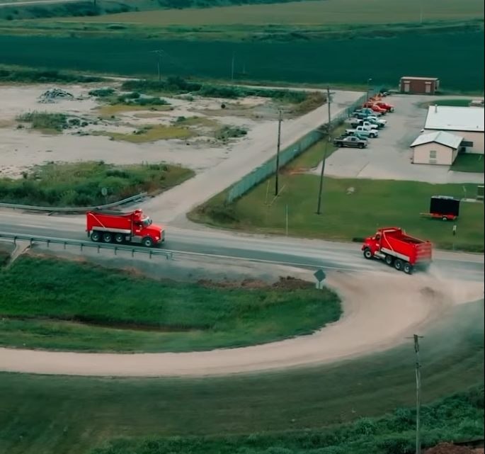 Haul trucks delivering offsite fill at the Mound City TA Travel Center project